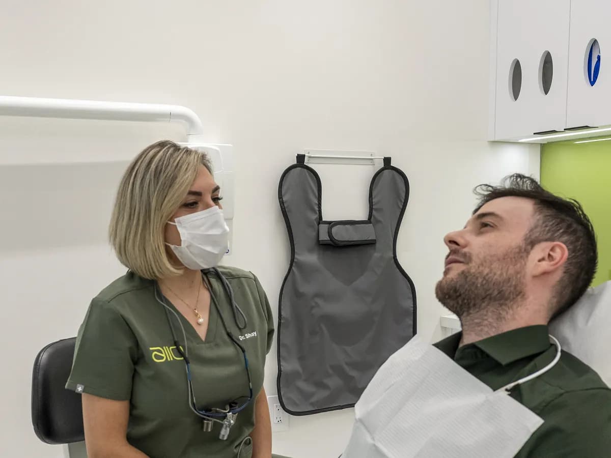 Dr. Shay Rahmatian talking through options with a smiling patient in the chair